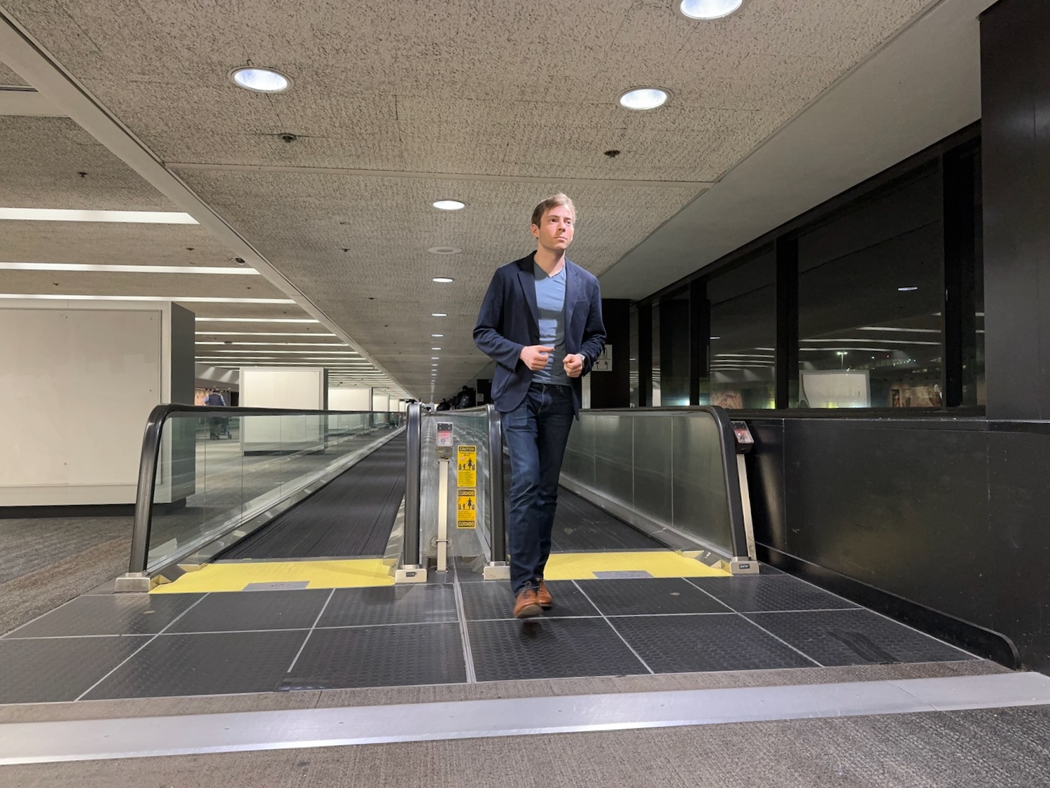 a man standing on an escalator