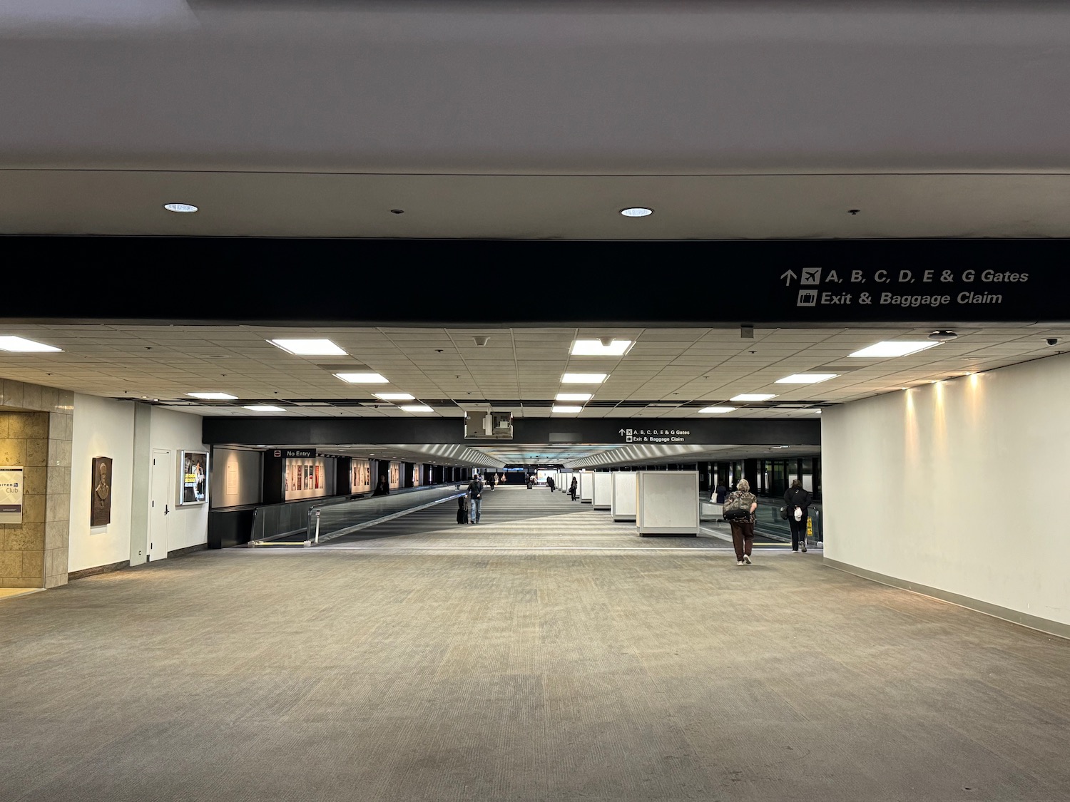 a large hallway with people walking in it