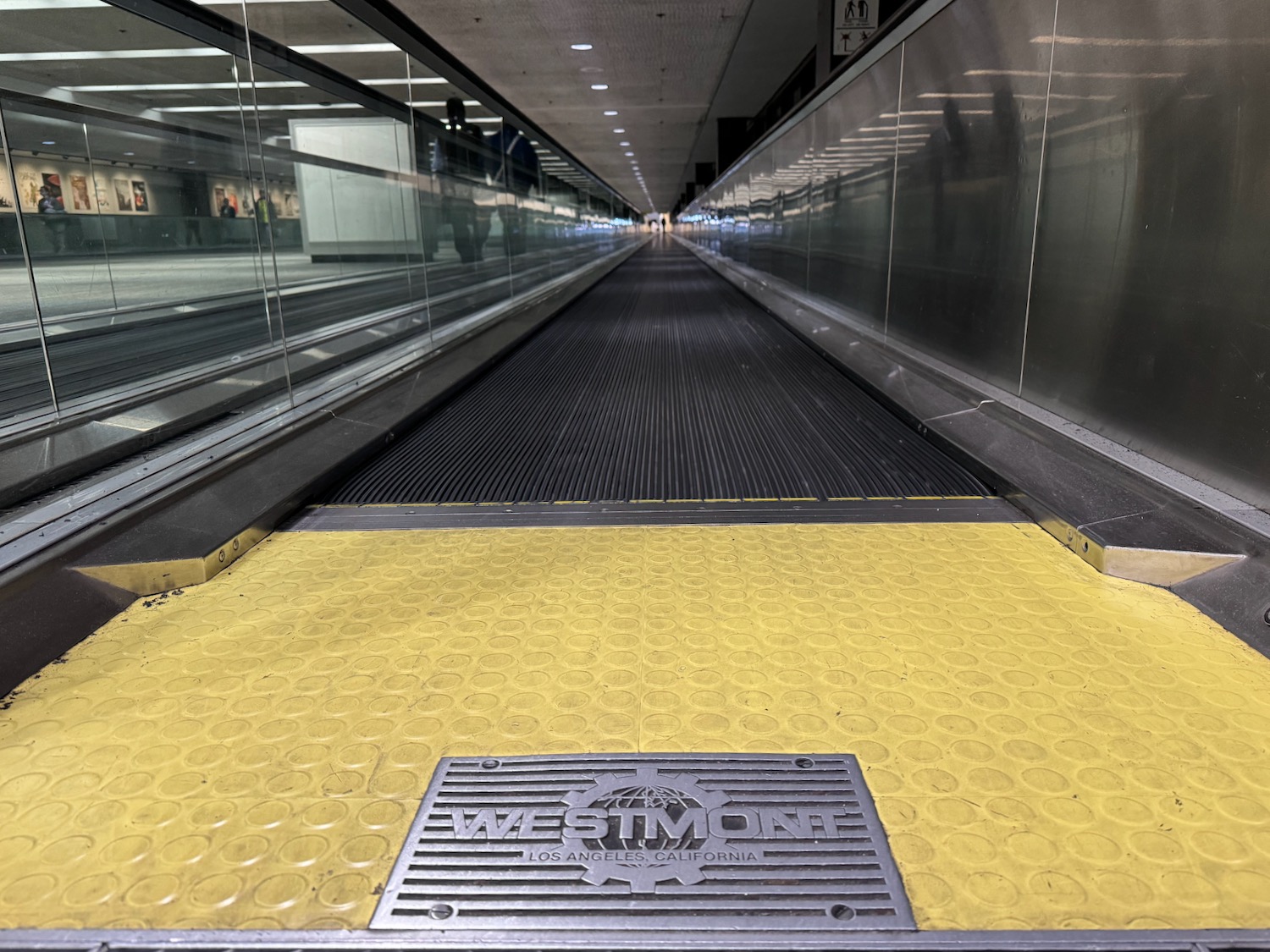 a walkway with a metal grate and a metal railing