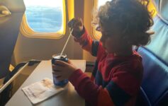 a child sitting in a chair on an airplane