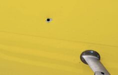 a hole in a yellow wall