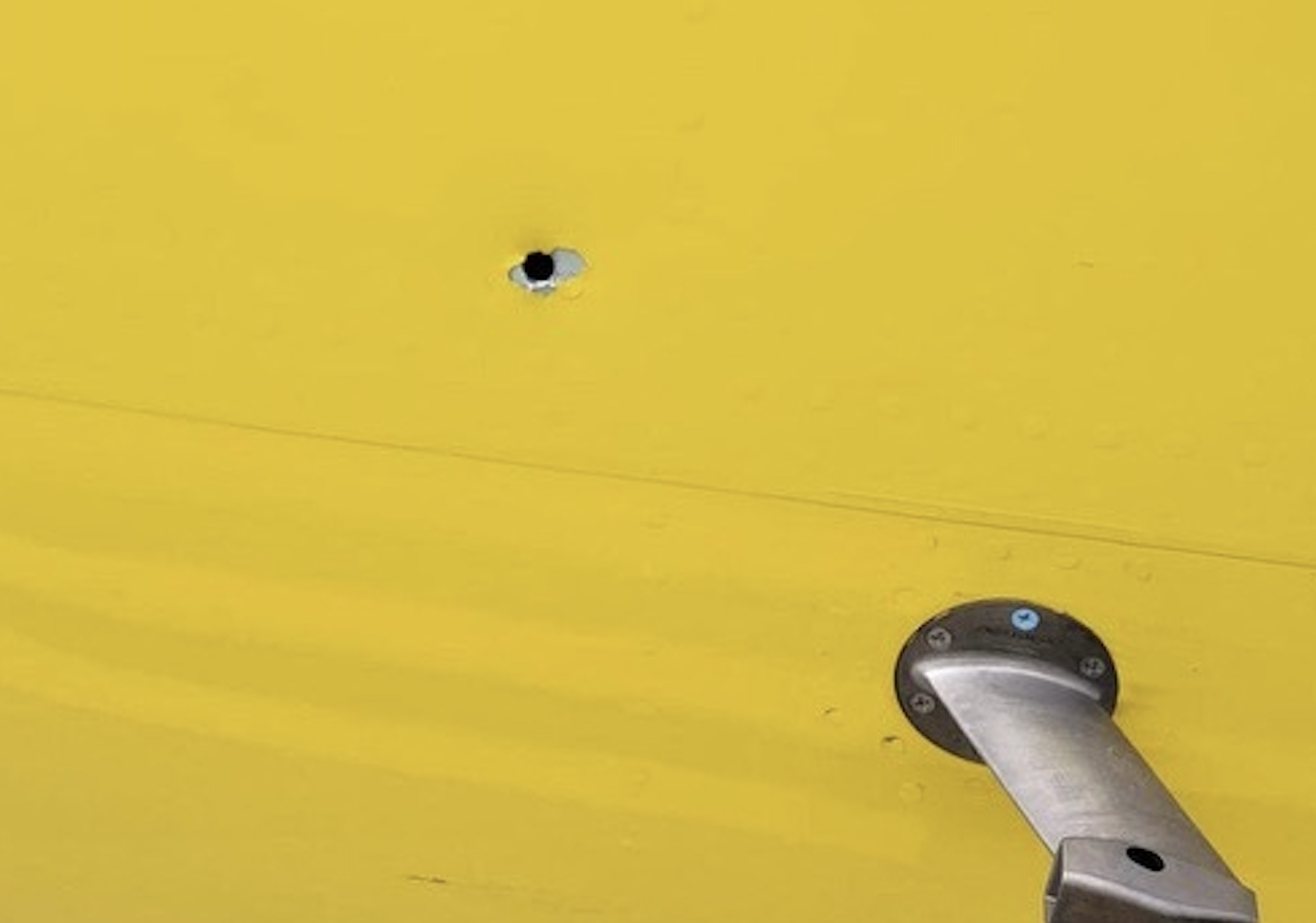 a hole in a yellow wall