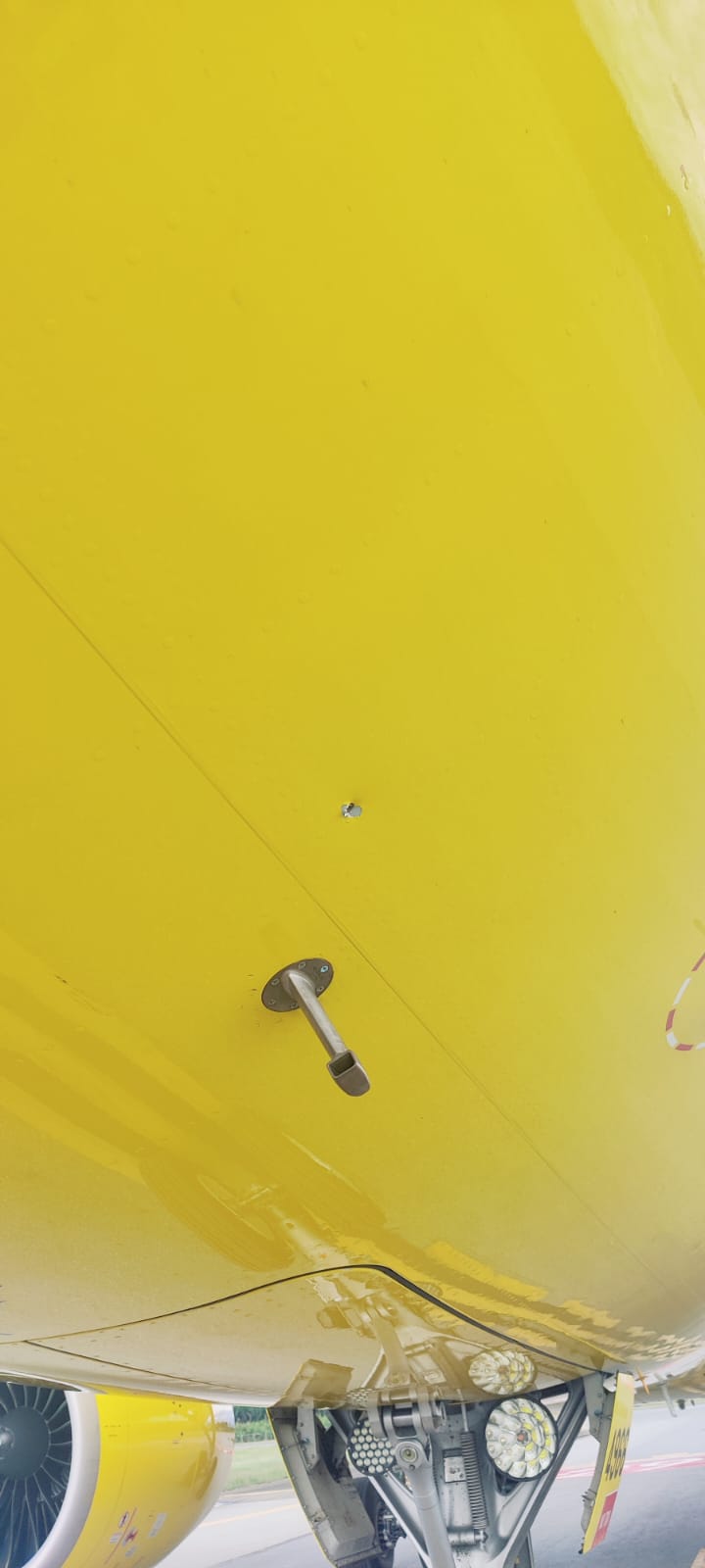 a metal pole on a yellow surface