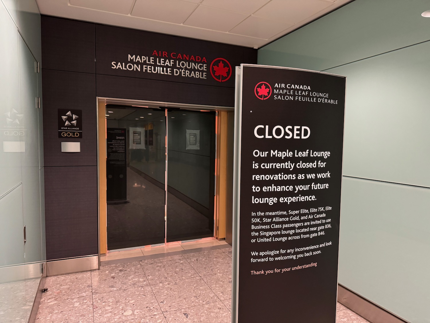 a sign in front of a closed elevator