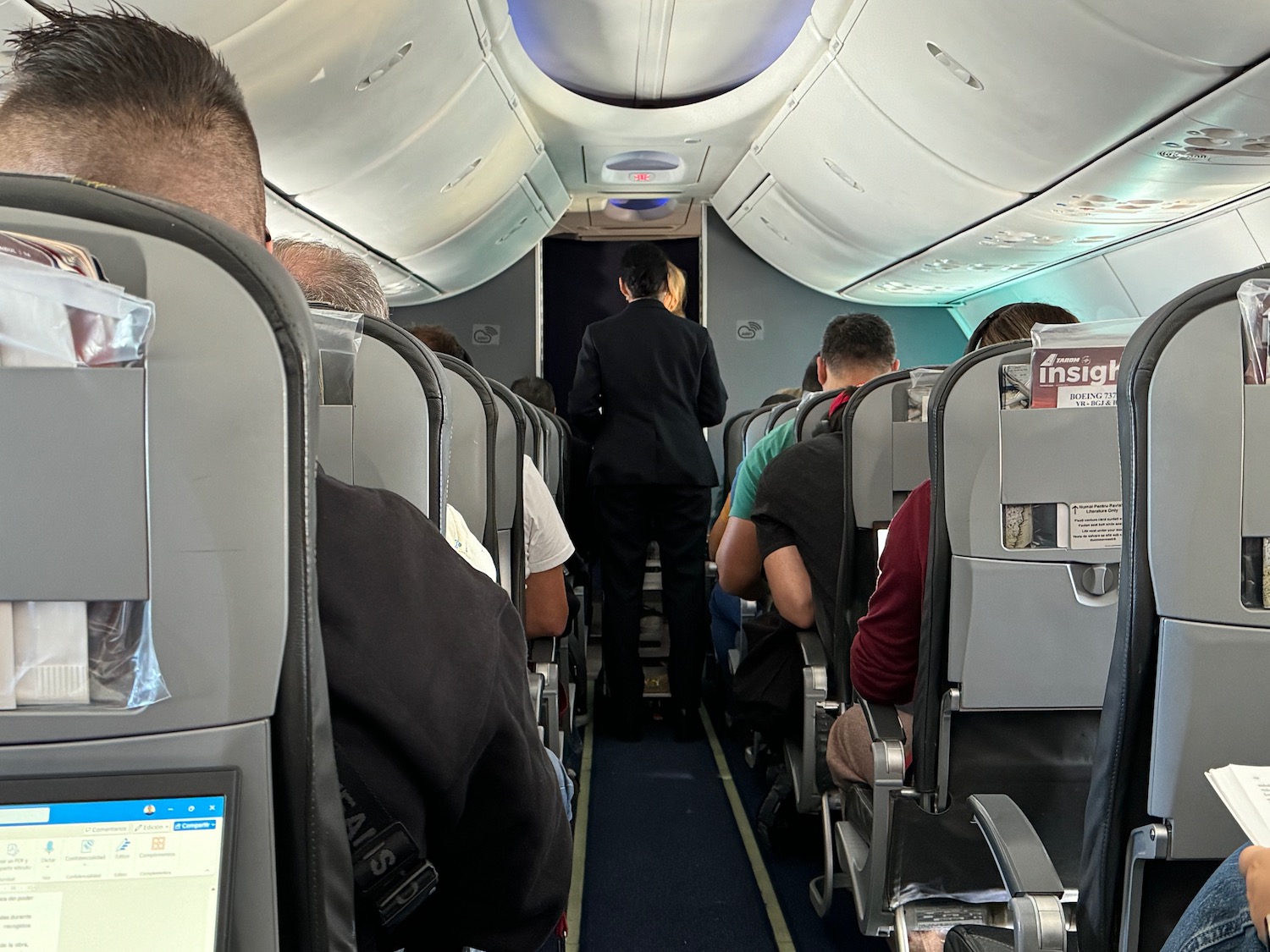 a person standing in the back of an airplane