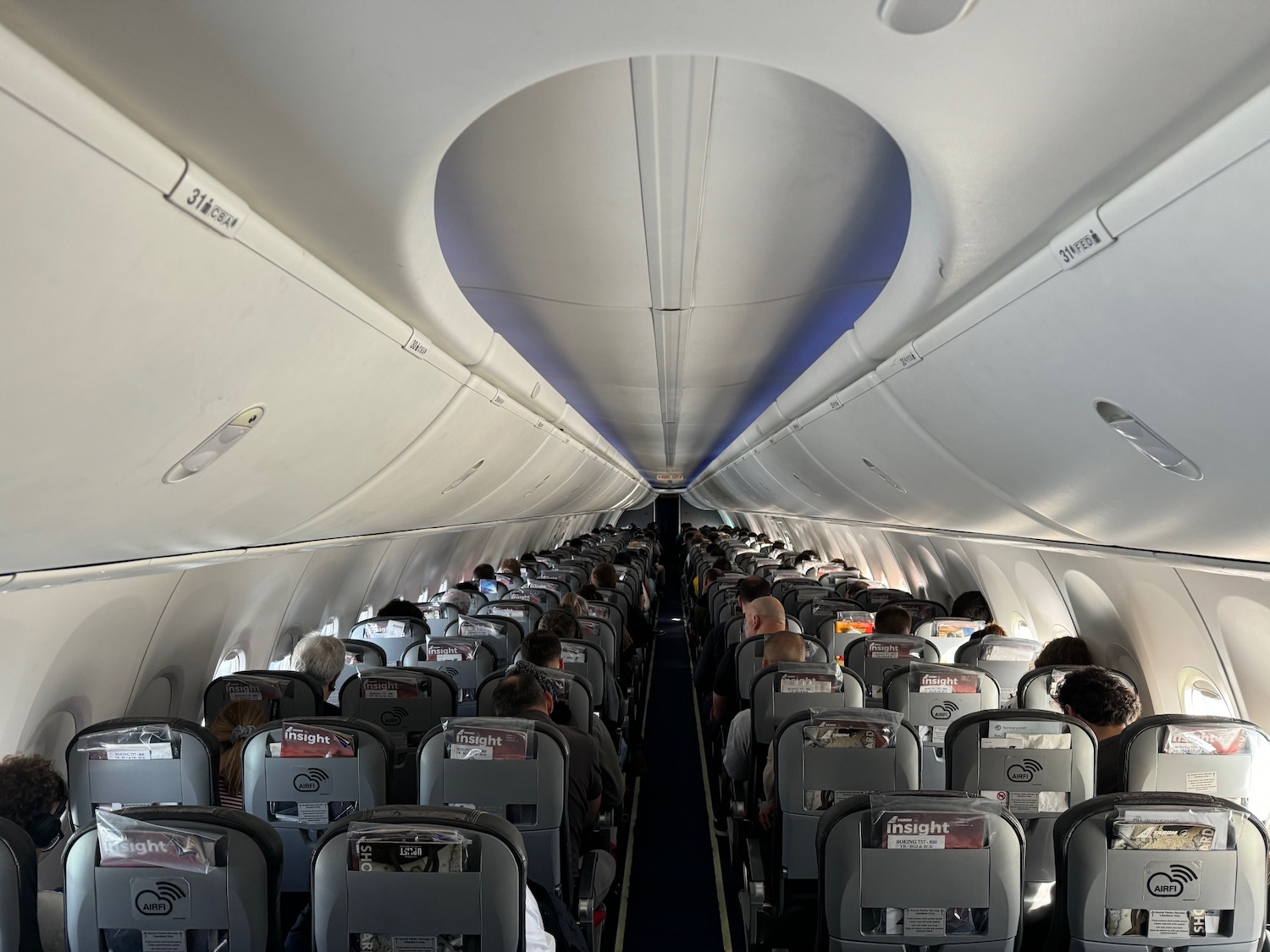 a plane with people sitting in the seats