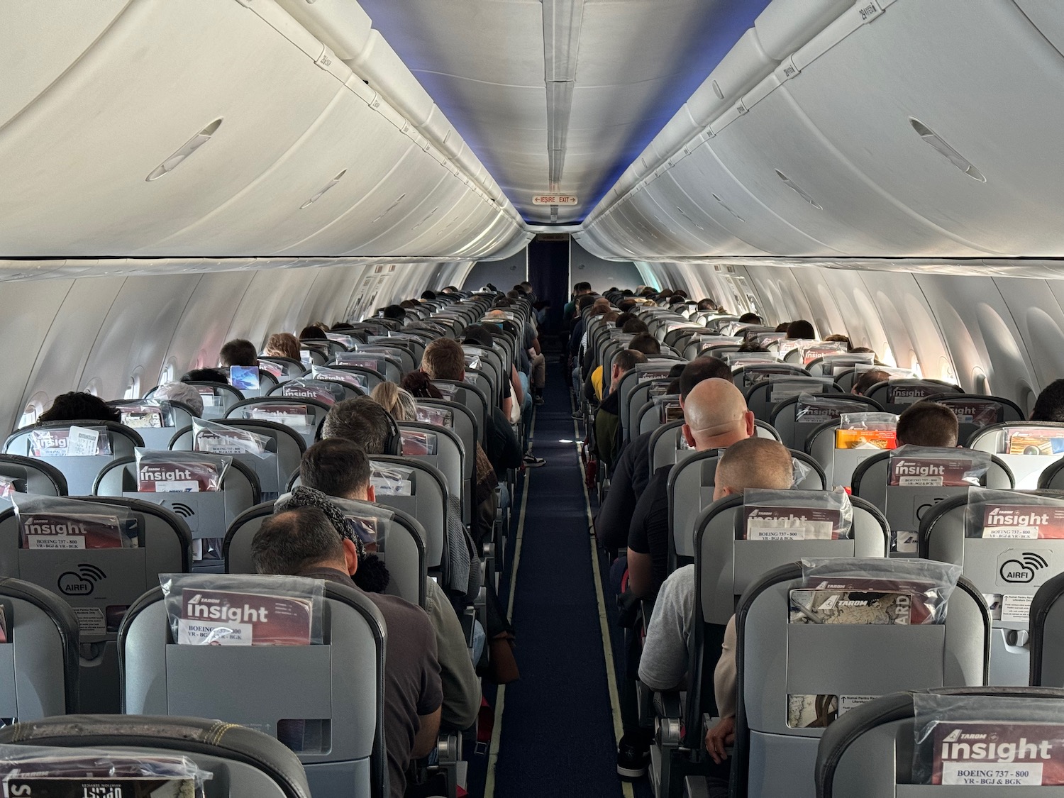 a group of people sitting in an airplane