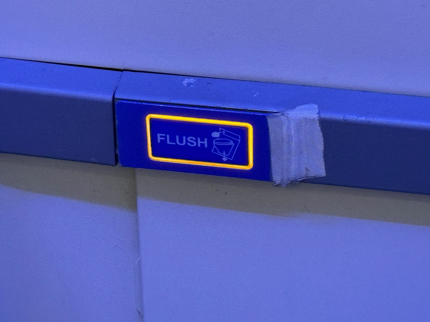 a blue sign with a yellow light on it