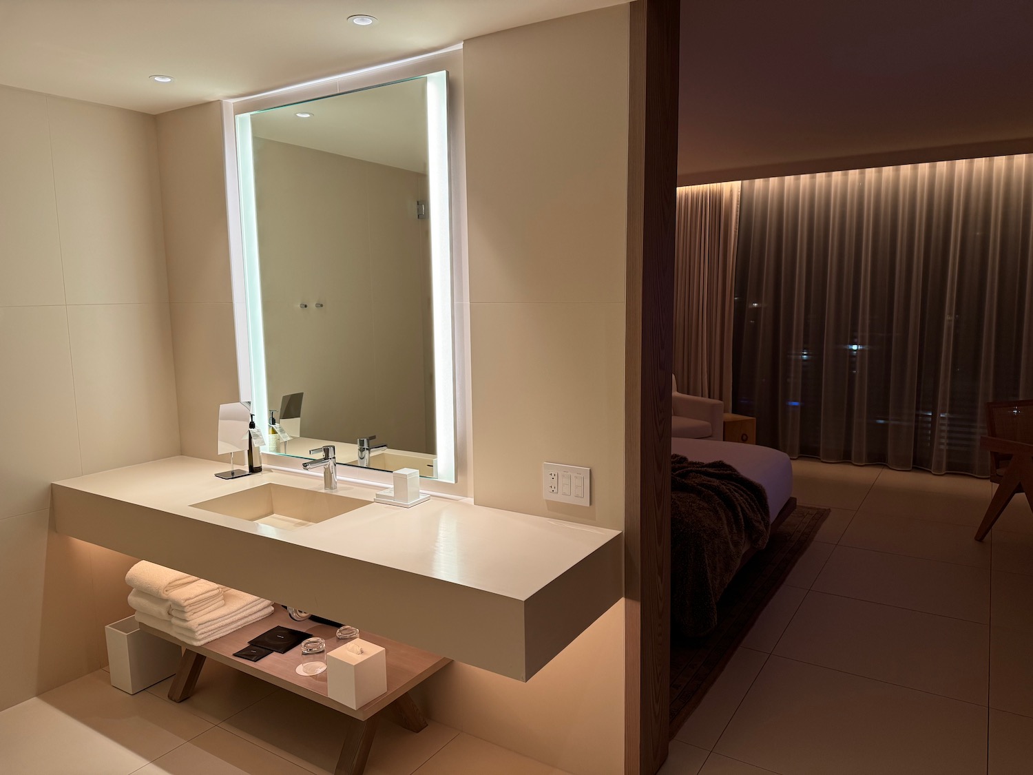 a bathroom with a large mirror and a bed