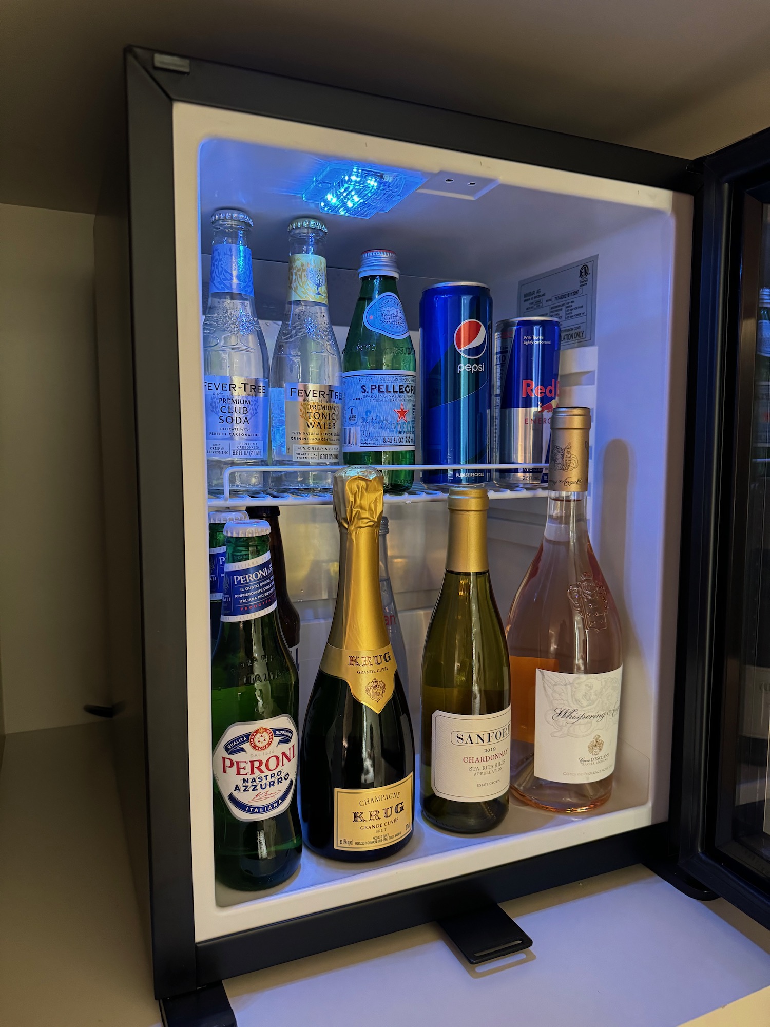 a mini fridge with bottles of alcohol