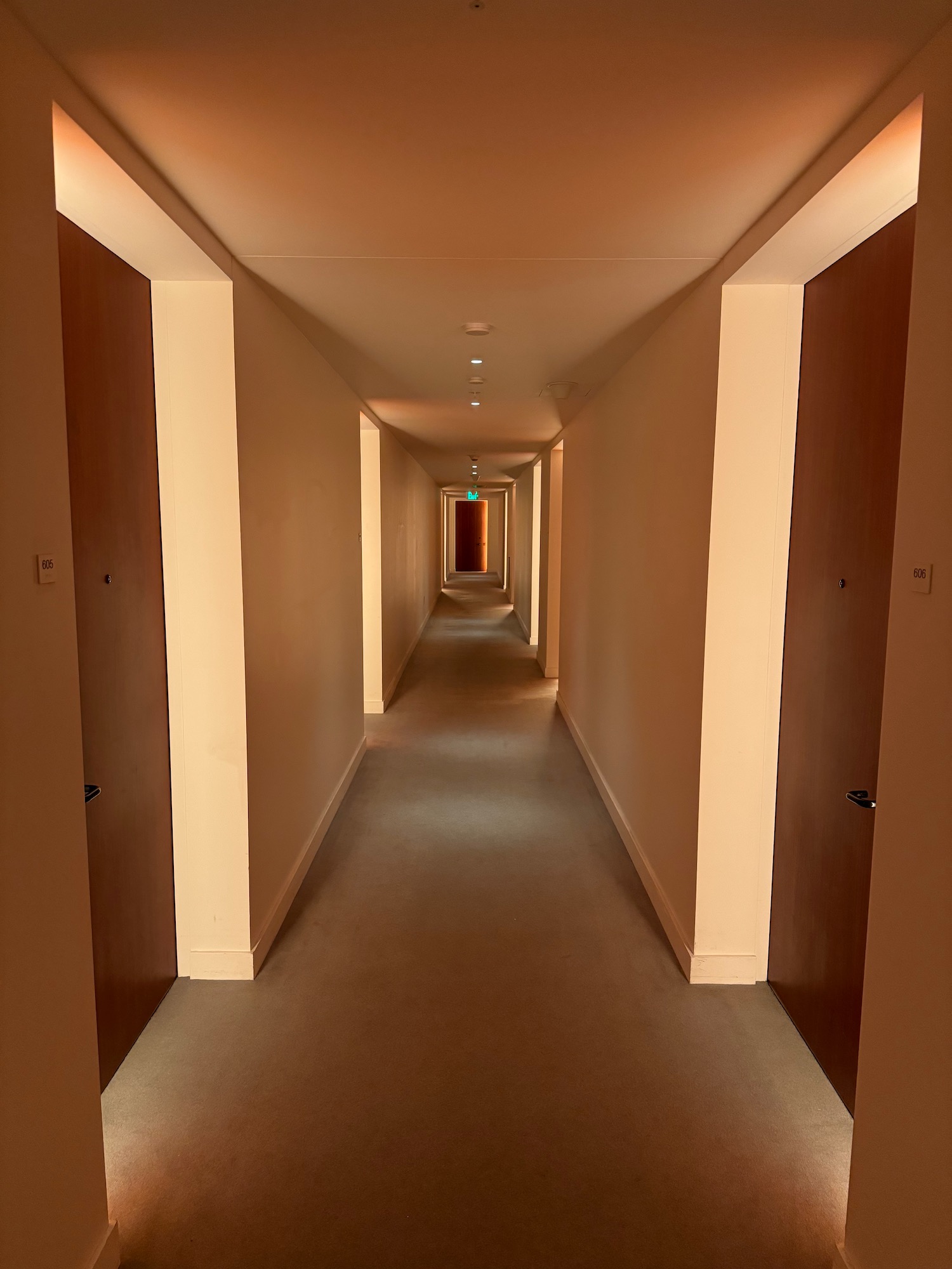 a hallway with doors and a light on the ceiling