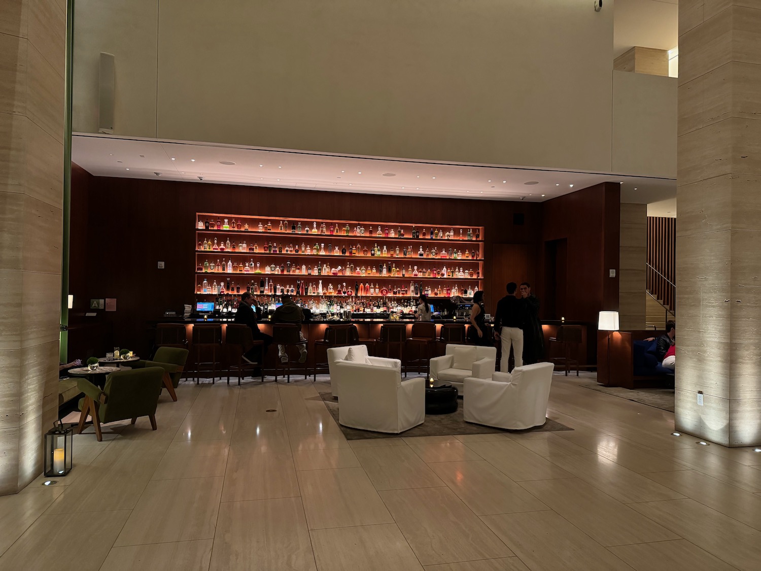 a room with a bar and a shelf with bottles of alcohol