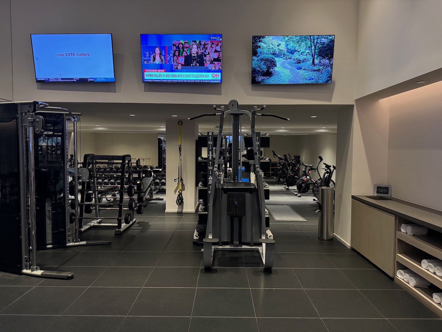 a gym with several monitors and a few equipment