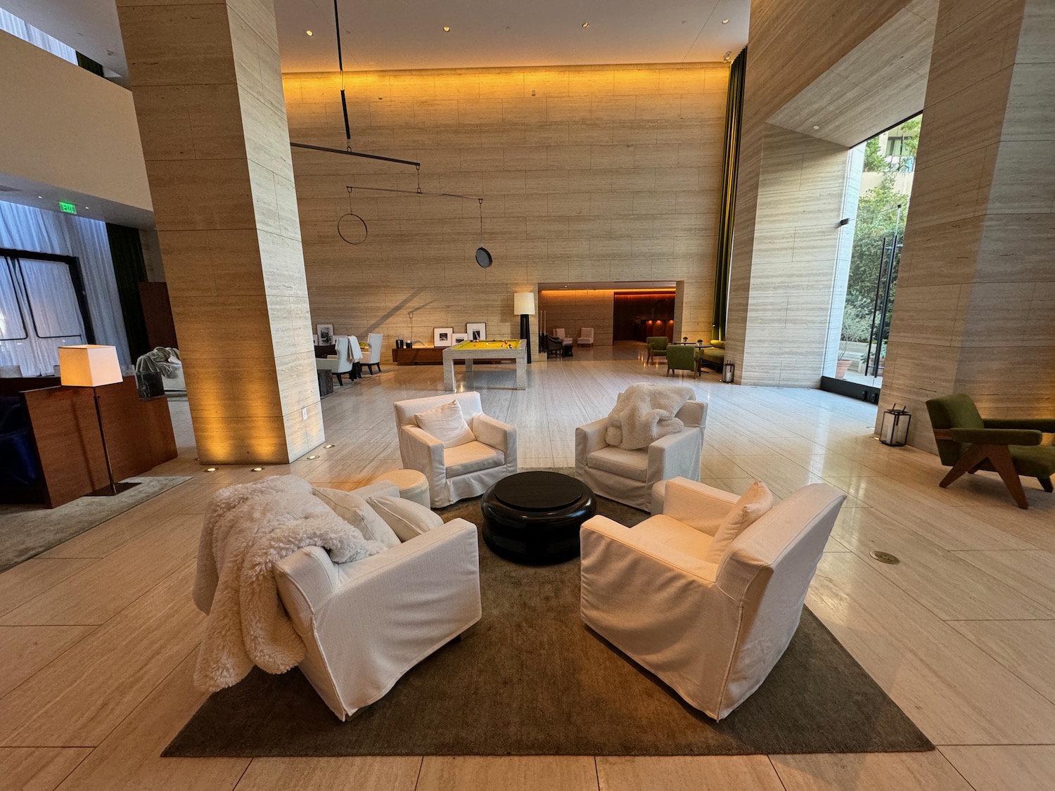 a room with white chairs and a black round table