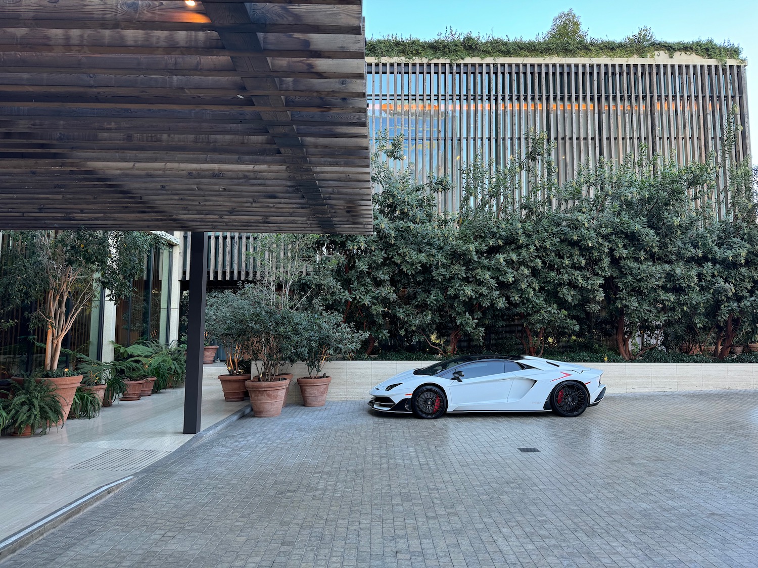 a white sports car parked in a driveway