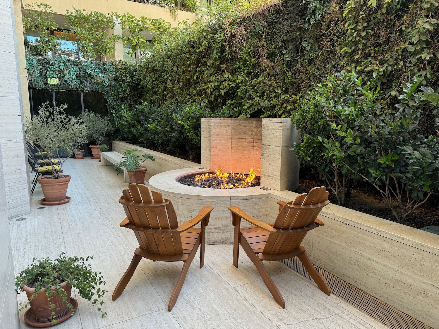 two chairs on a patio with a fire pit