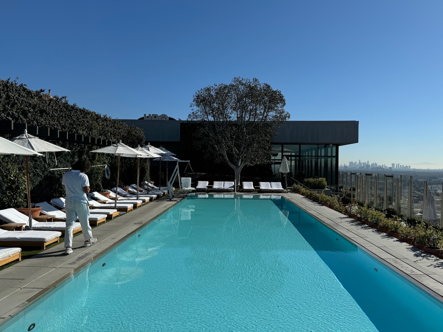 a man standing next to a pool