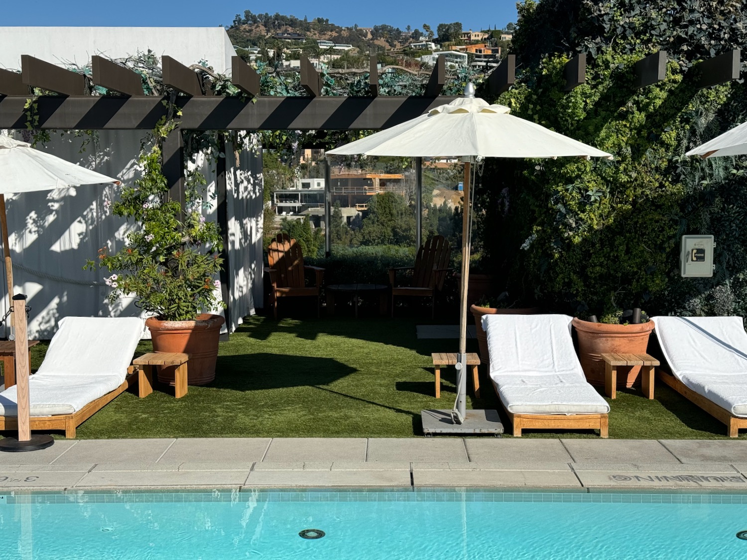 a pool with lounge chairs and umbrella