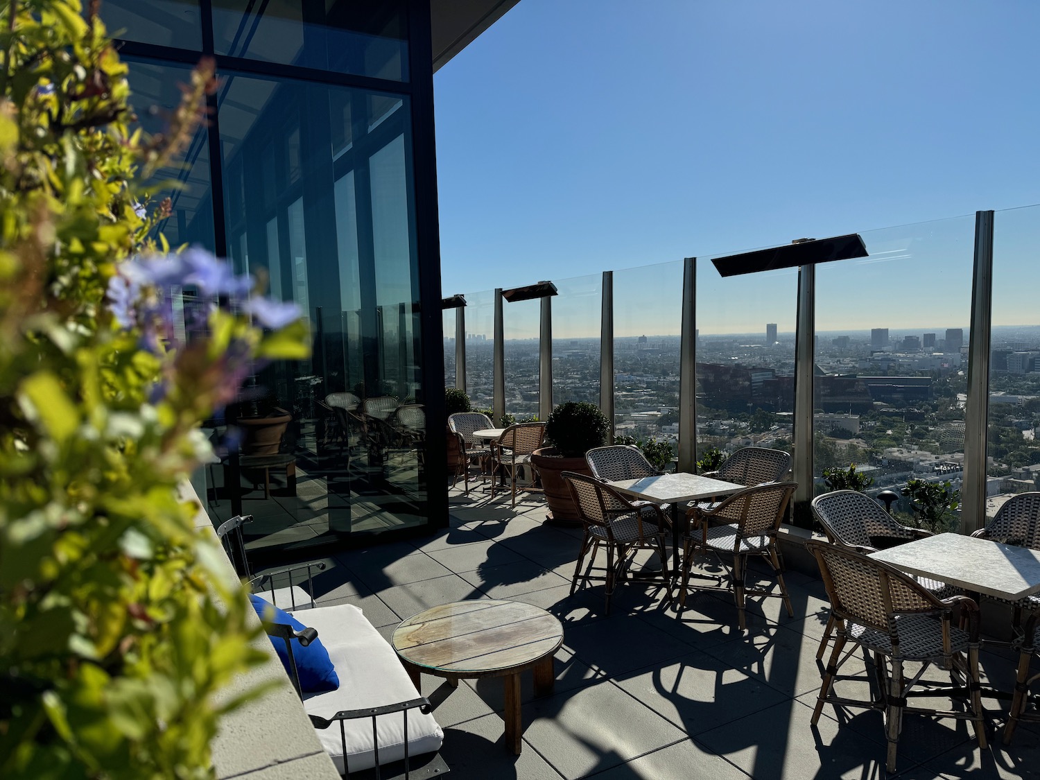 a rooftop patio with tables and chairs