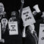 a group of people holding signs