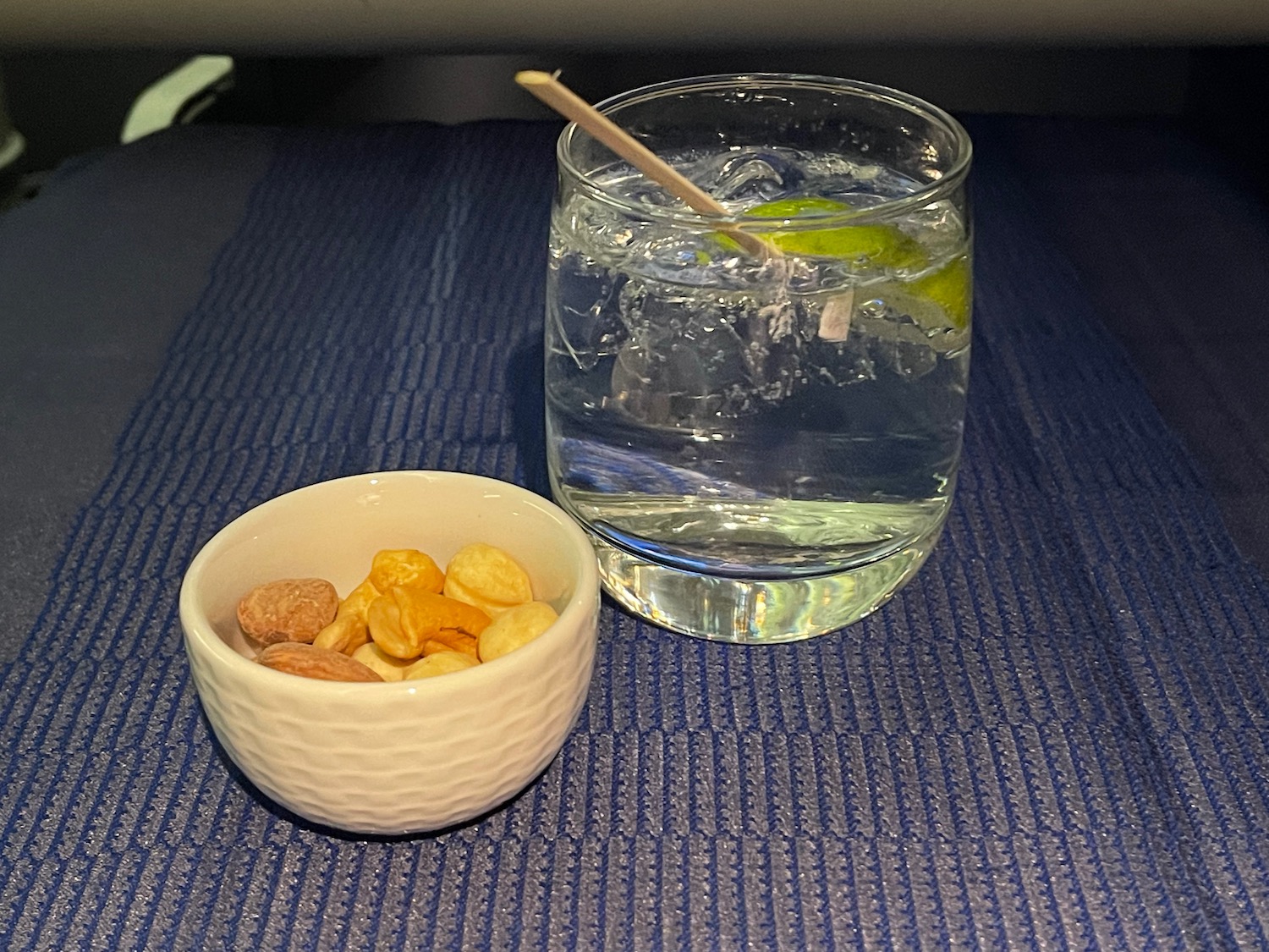 a bowl of water and a glass of water with a spoon