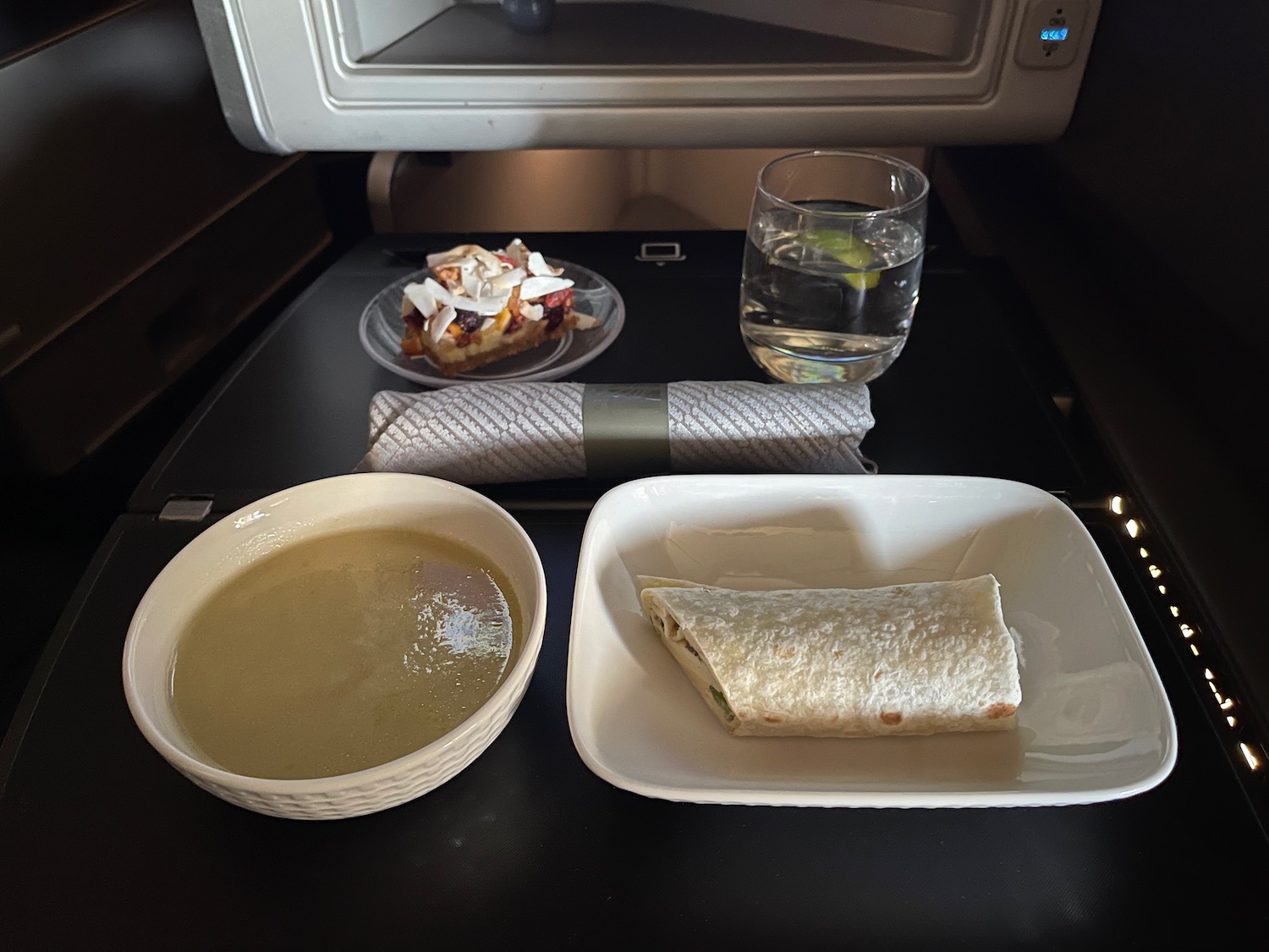 a plate of food and a glass of water on a table