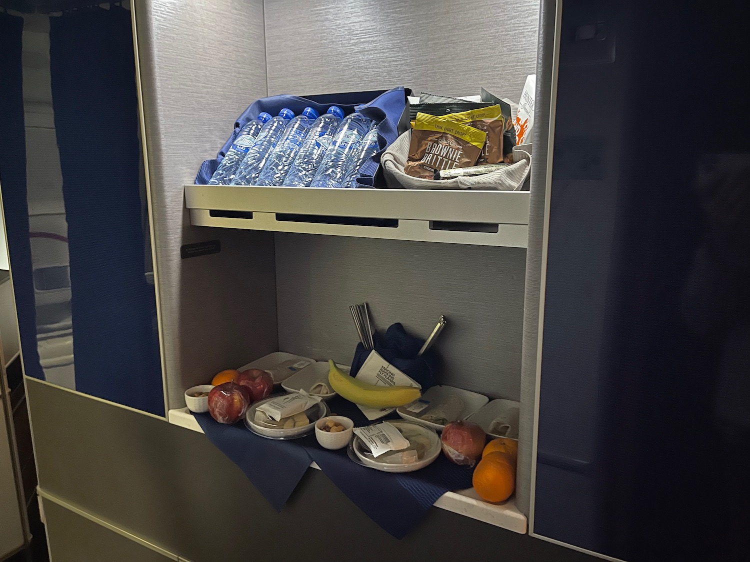 a shelf with food and drinks on it