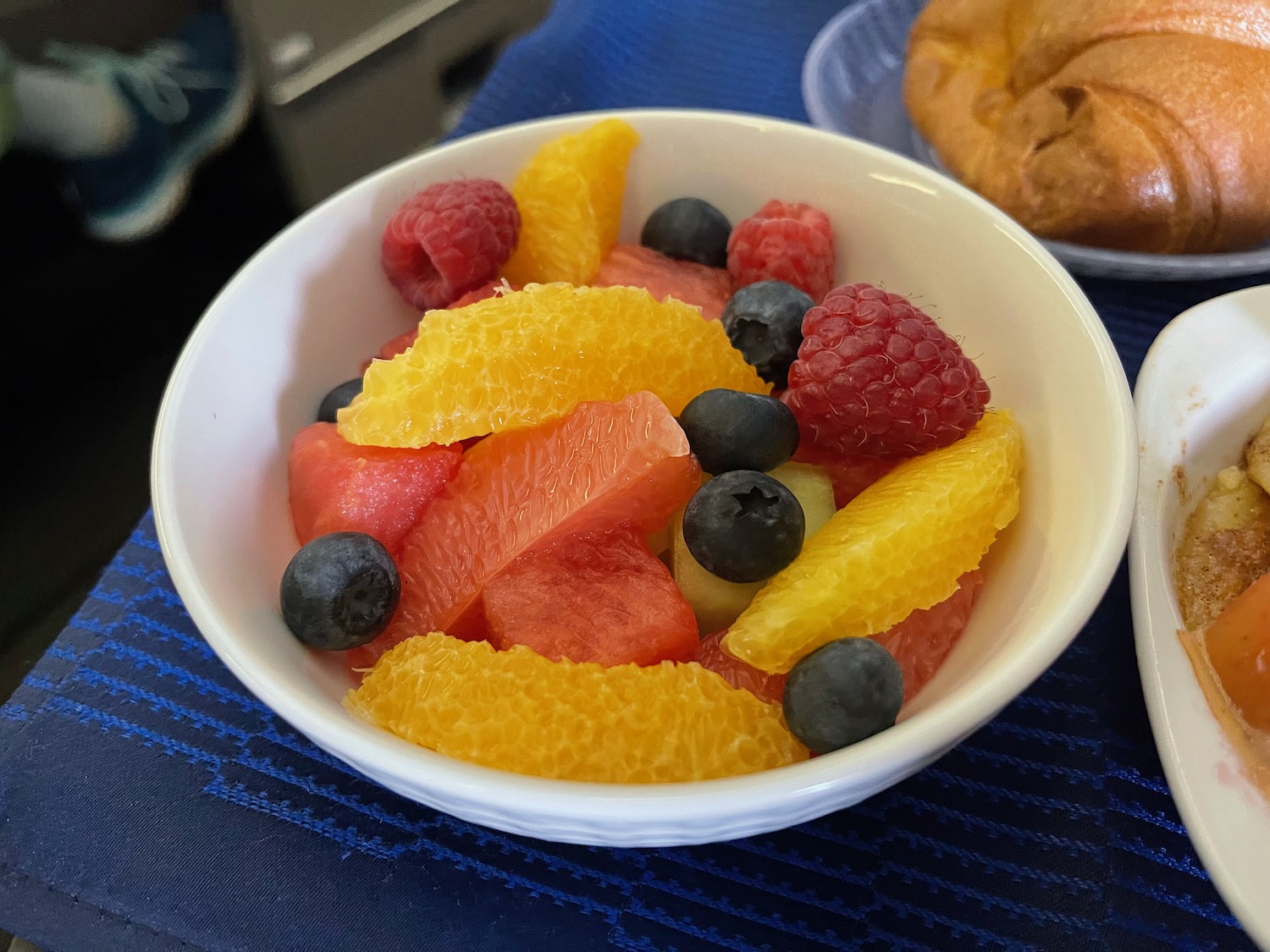 a bowl of fruit on a table