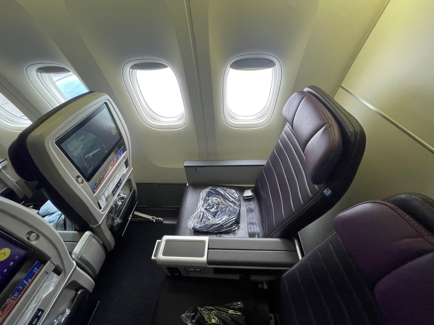 an airplane seat with windows and a television