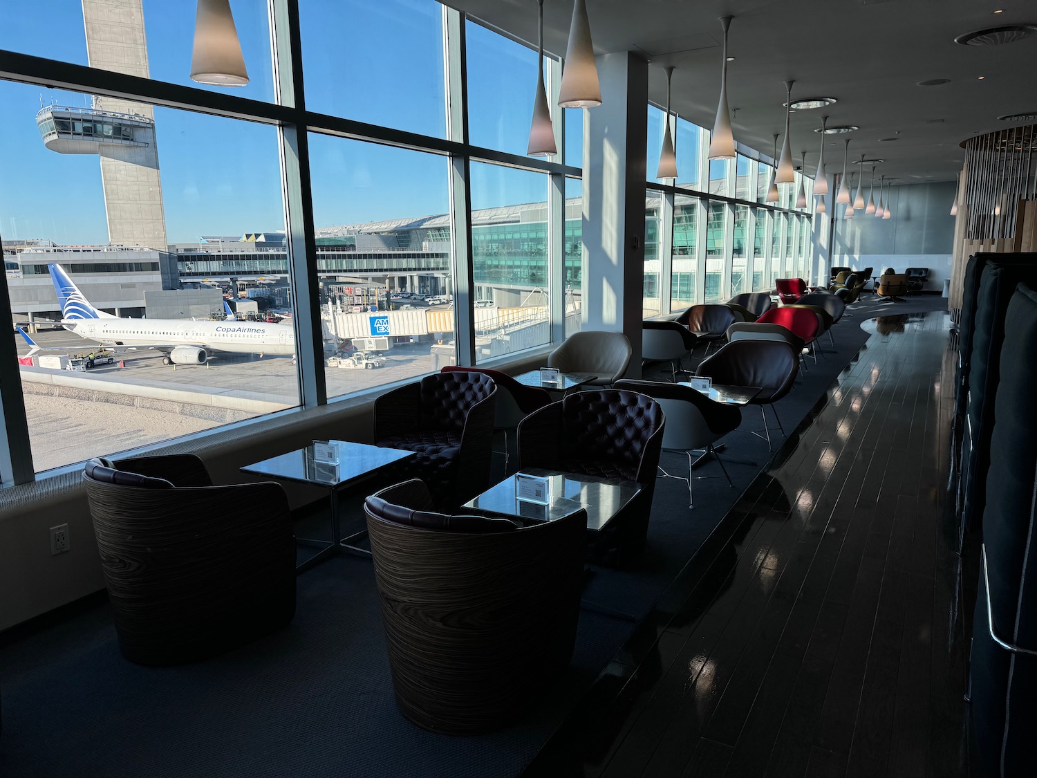 a row of chairs in a room with windows