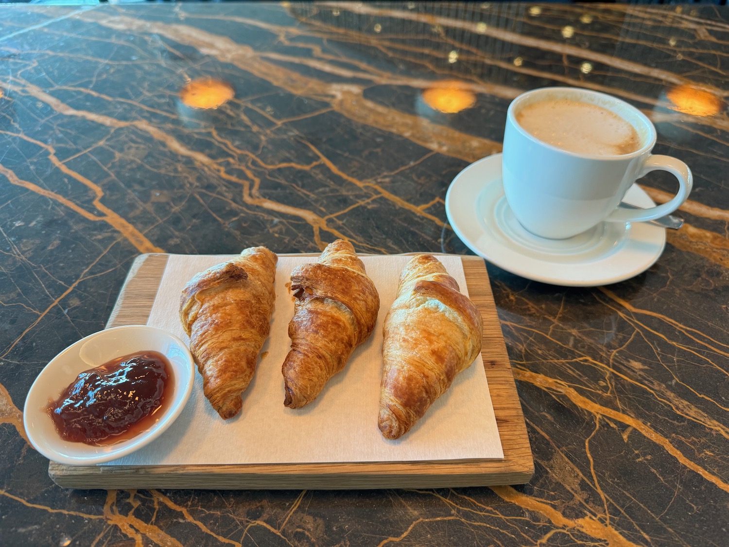 a plate of croissants and a cup of coffee