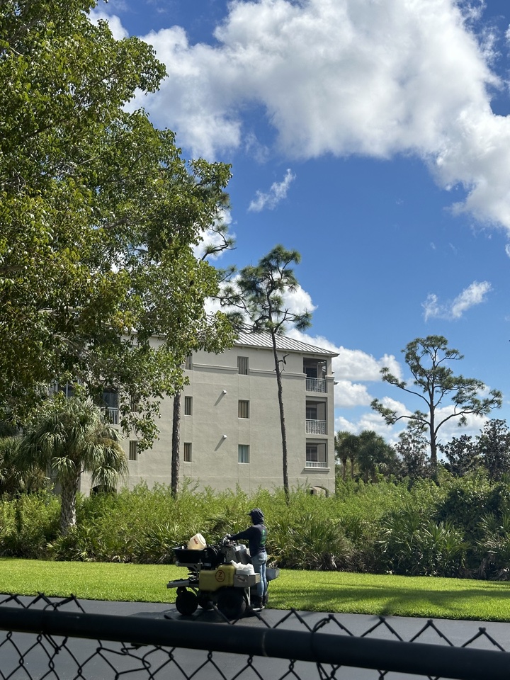 hyatt vacation club at coconut cove landscaper spraying fertilizer