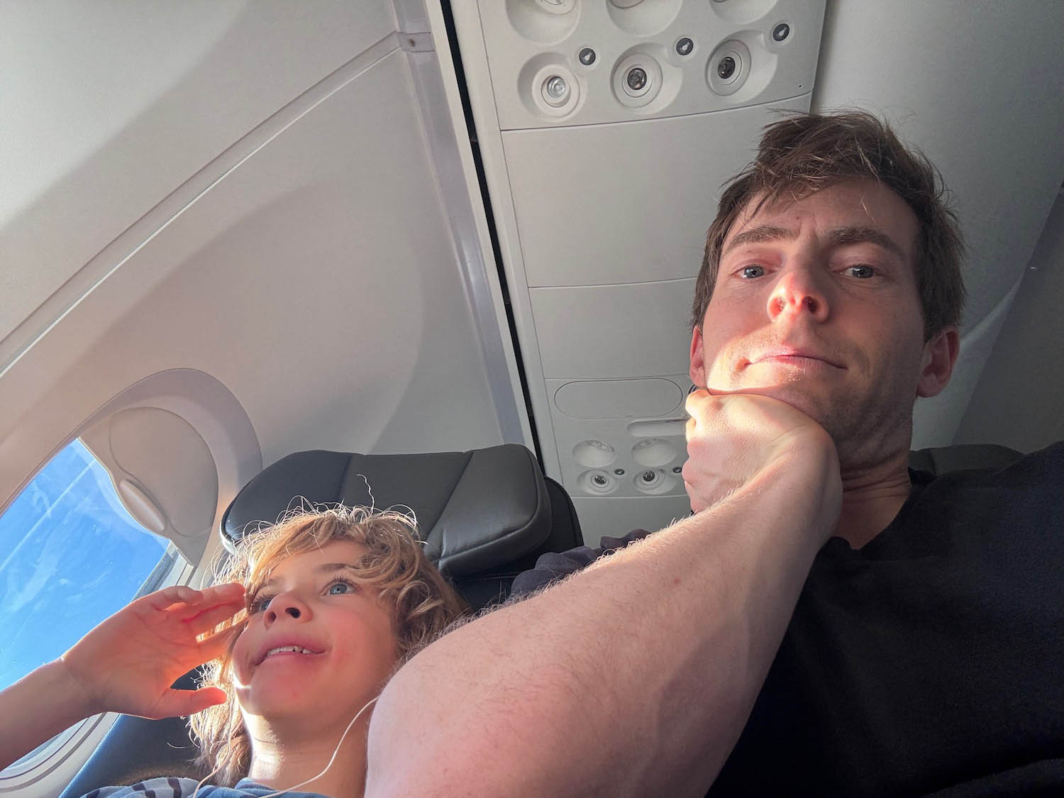 a man and child sitting in an airplane