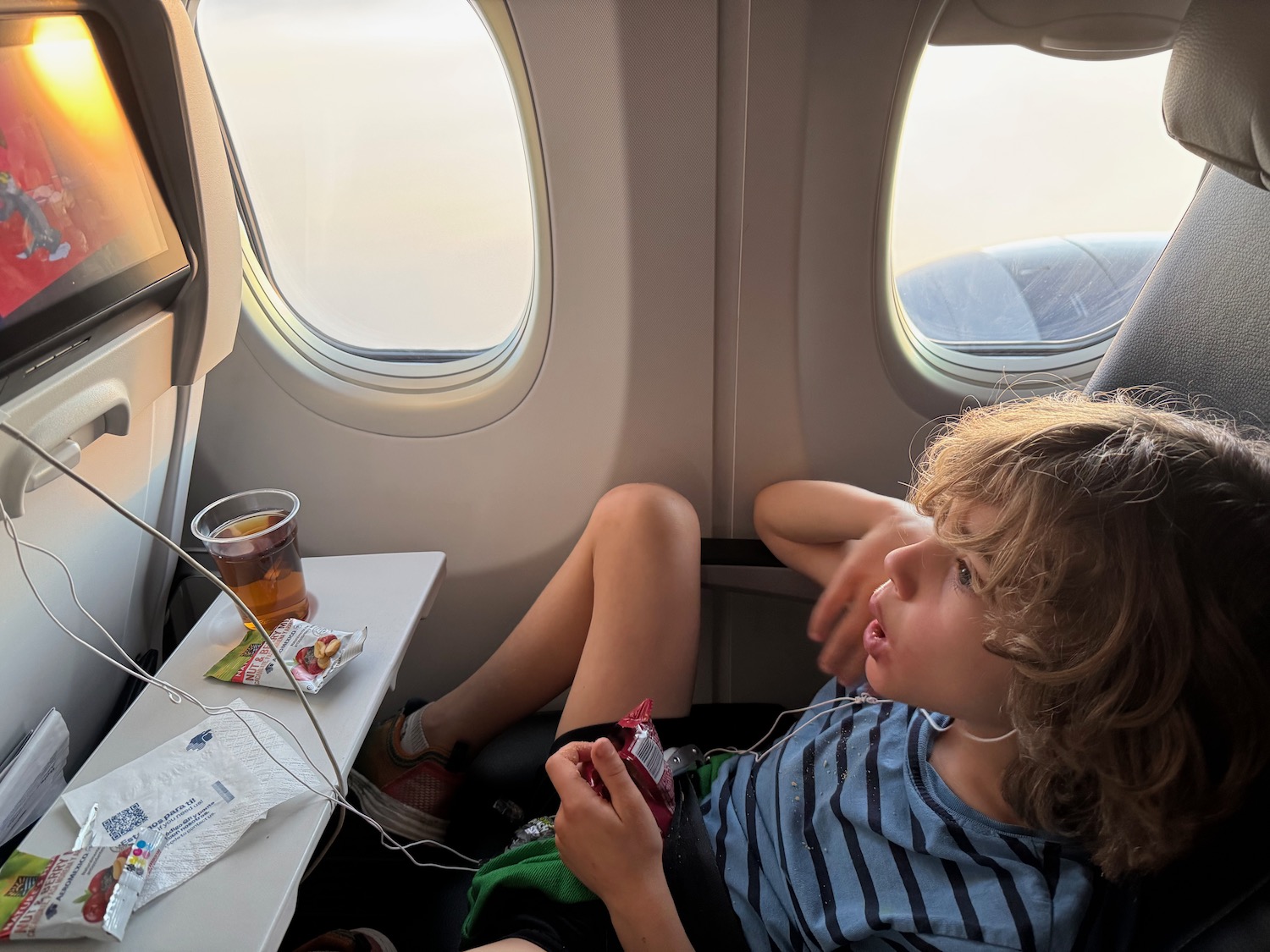 a boy sitting in an airplane