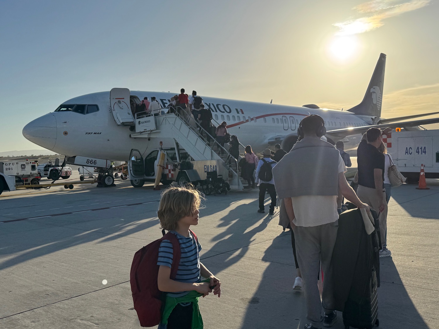 people walking on a runway with a plane