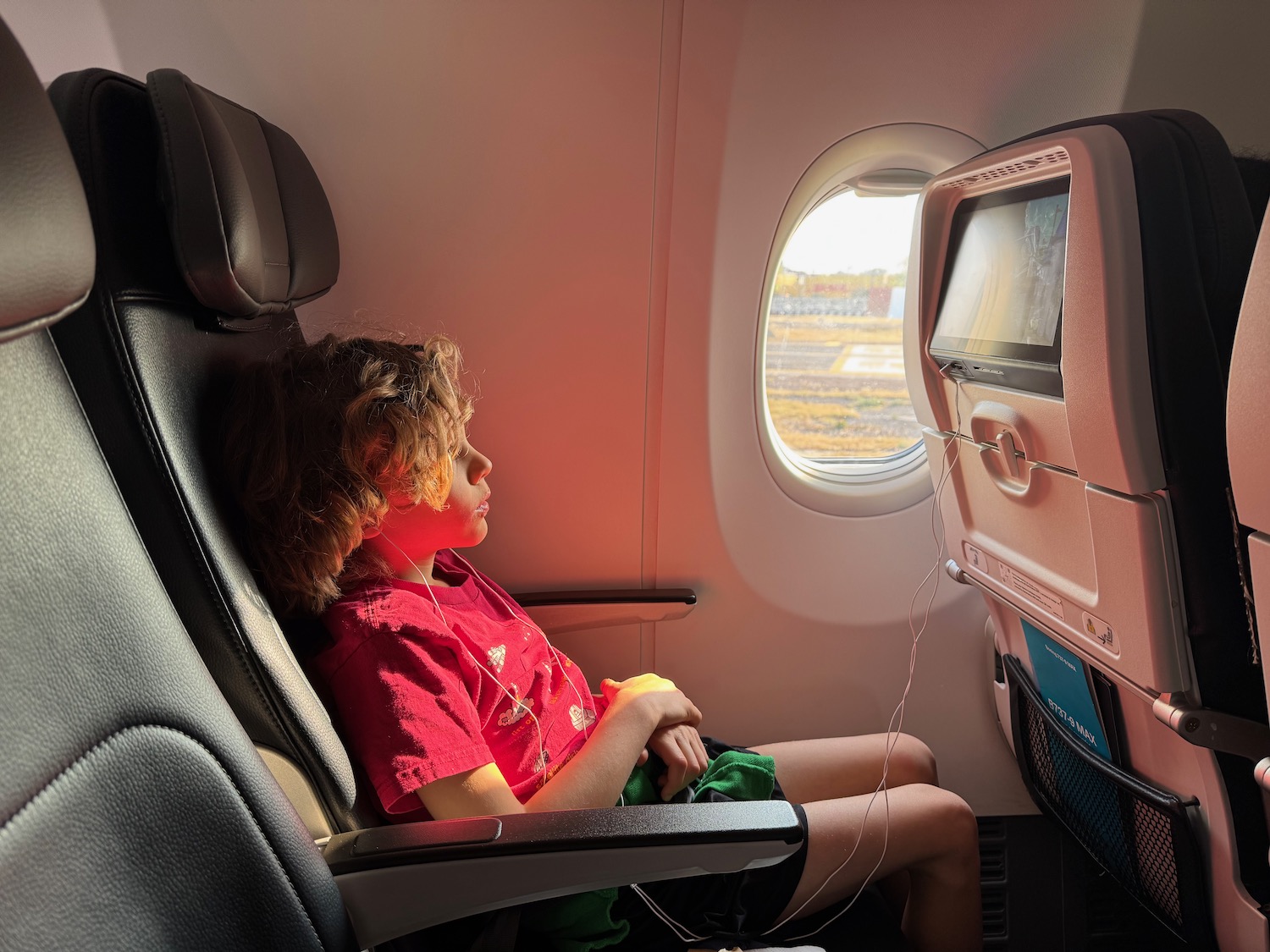 a boy sitting in a plane