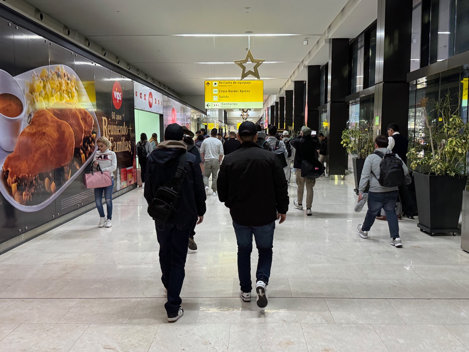 a group of people walking in a hallway