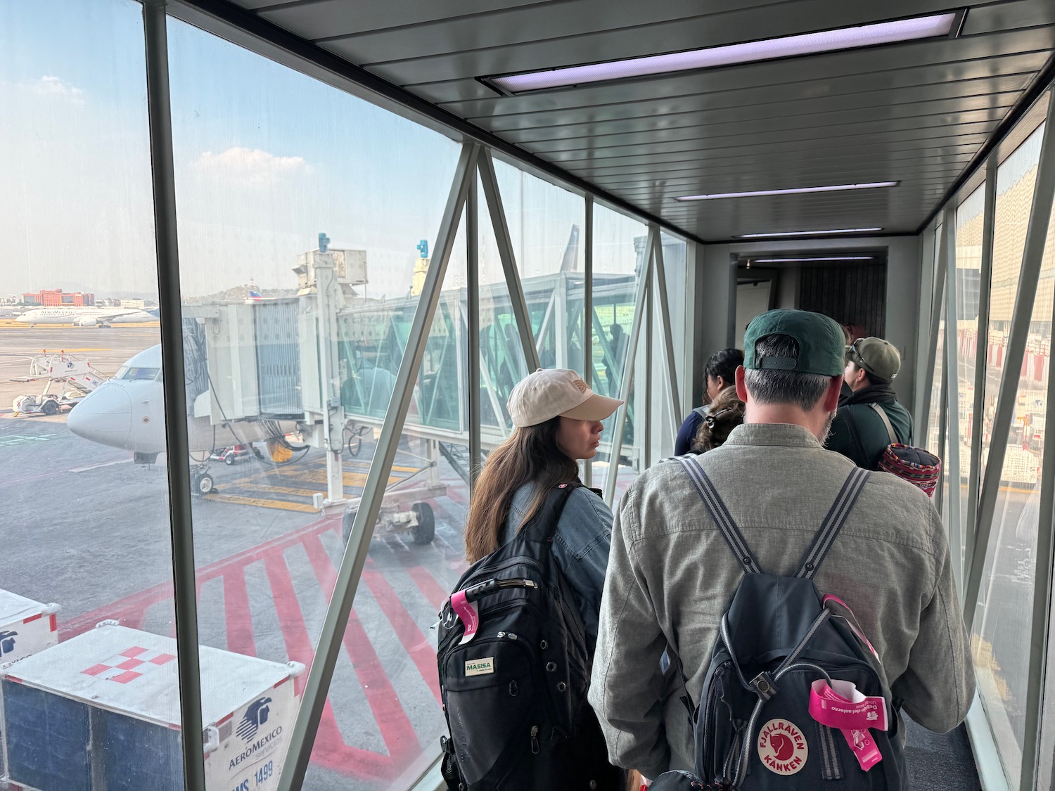 a group of people standing in a room with a window