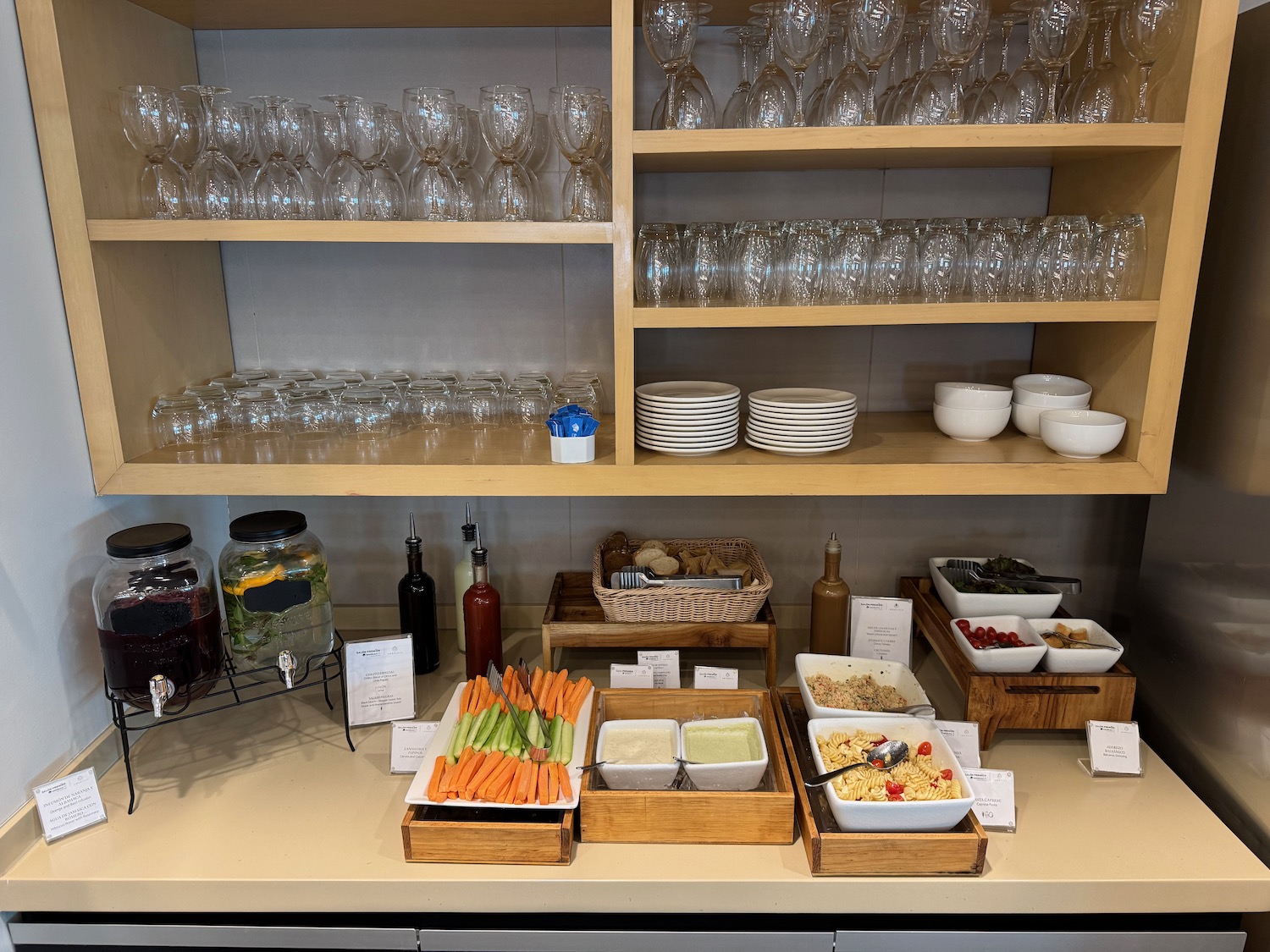 a shelf with food and glasses on it