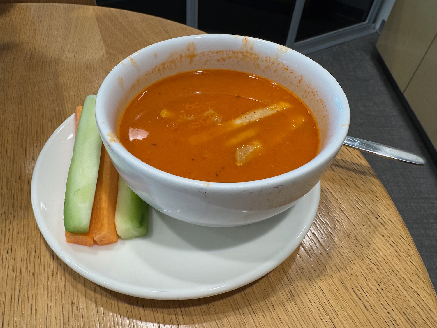 a bowl of soup and vegetables on a plate