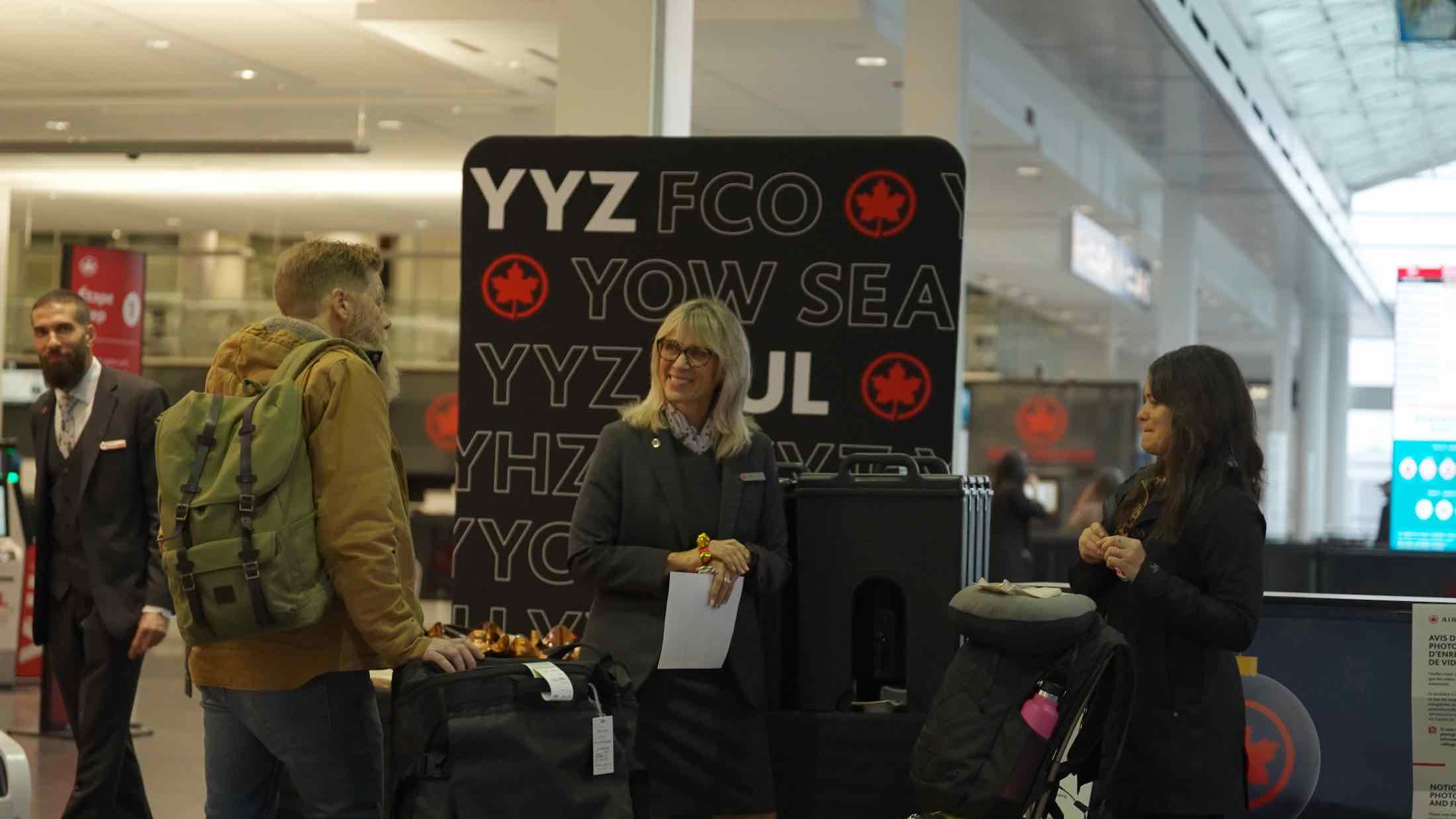 a woman standing next to luggage