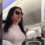 a woman in sunglasses on an airplane