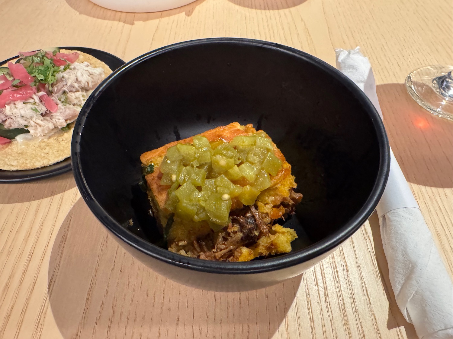 a black bowl with food in it