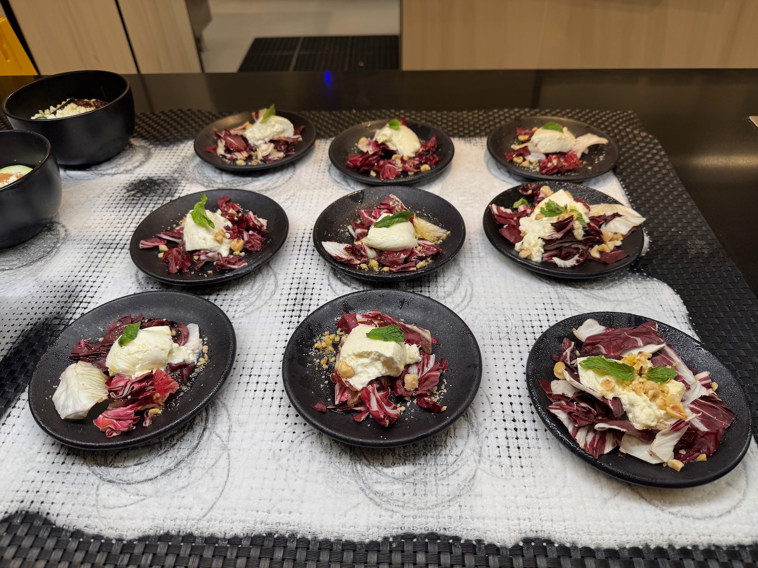 a group of black plates with food on them