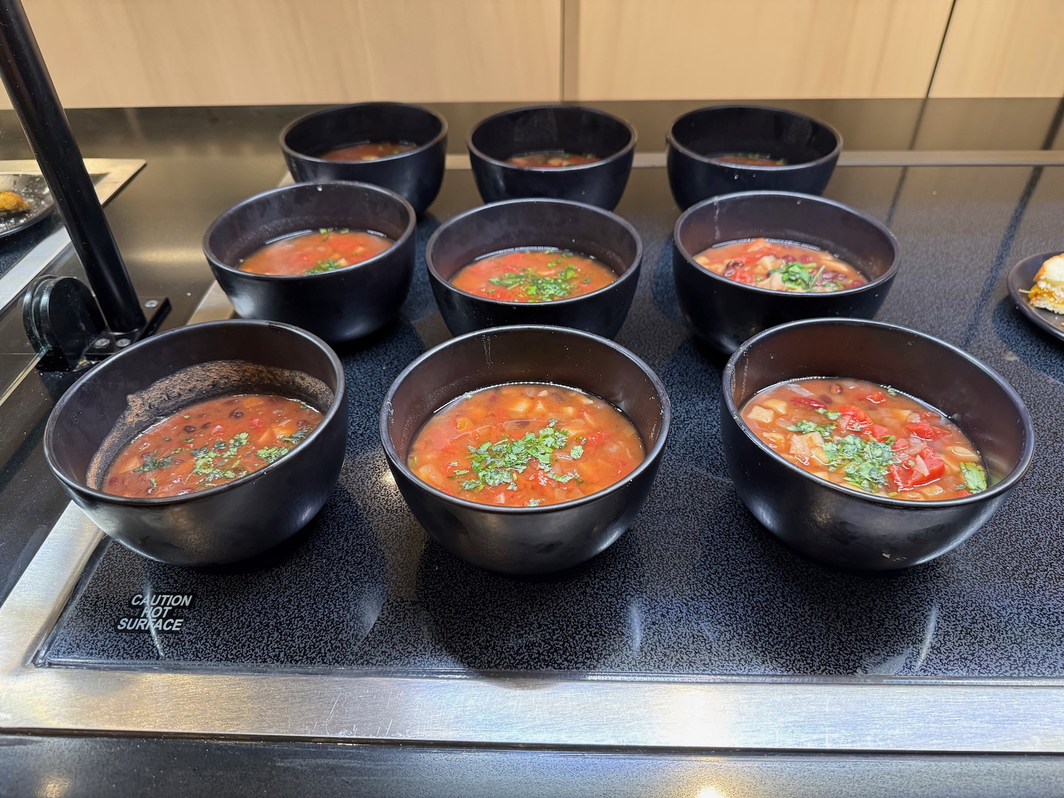 a group of bowls of soup on a stove