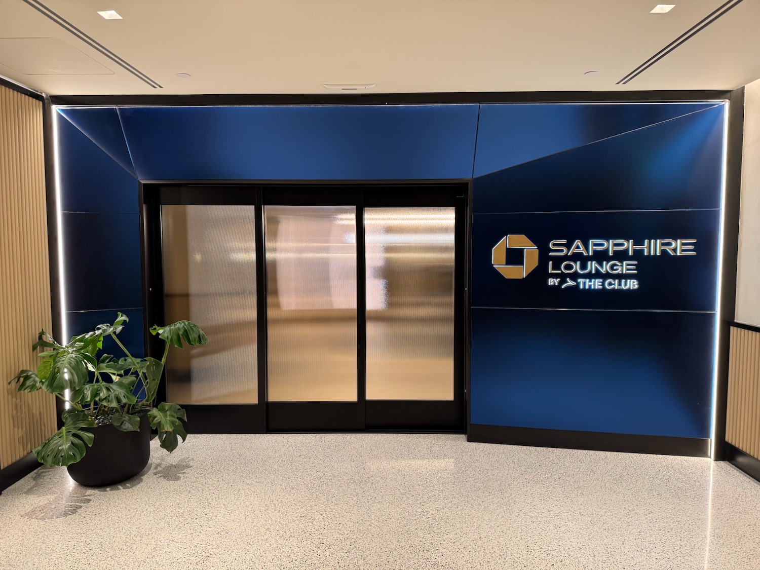 a blue sign with glass doors