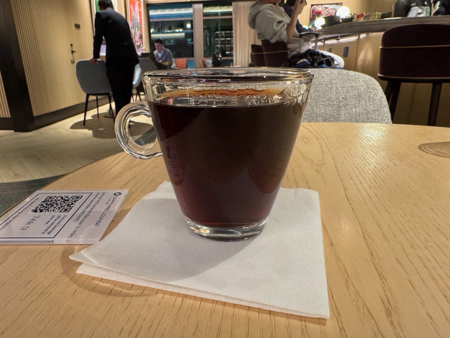 a glass cup of coffee on a table