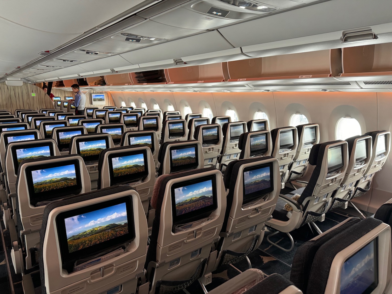 a row of seats with monitors on the back