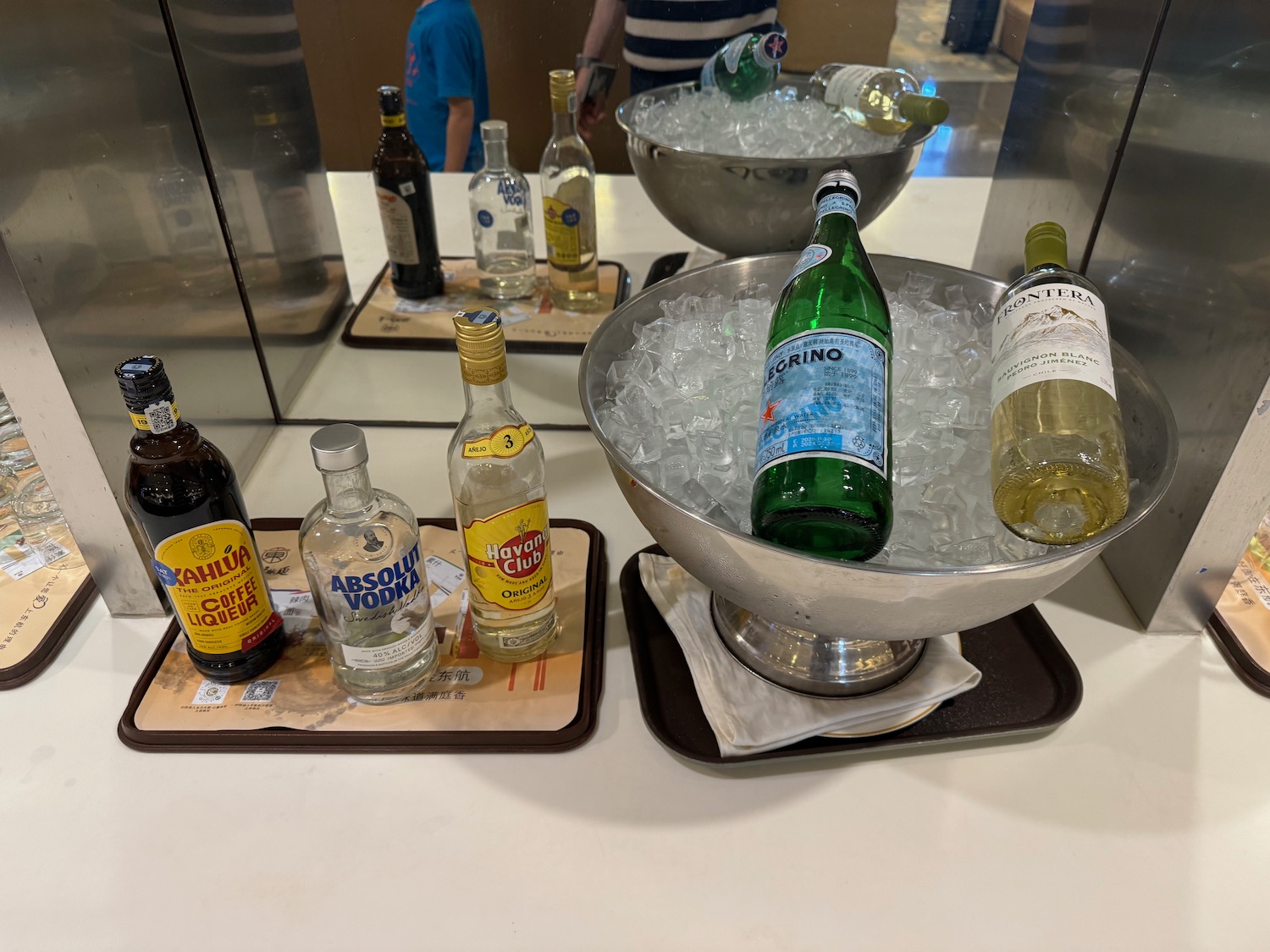 bottles in a bowl of ice and a bowl of liquid