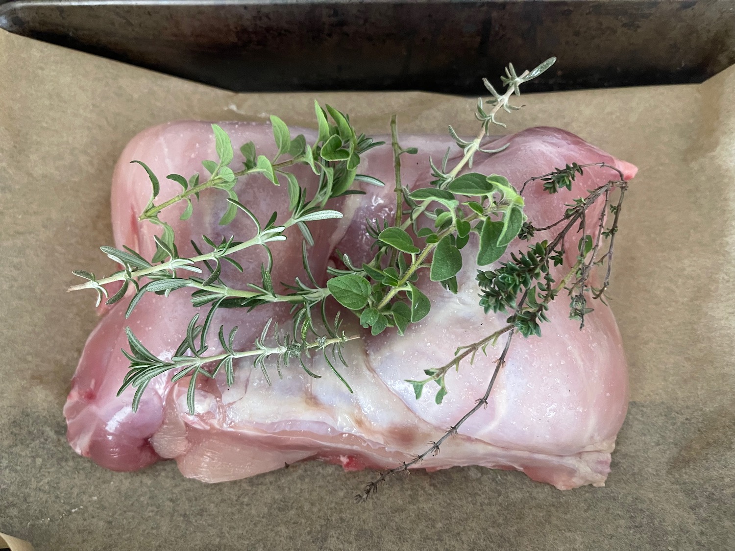 a raw meat with herbs on top